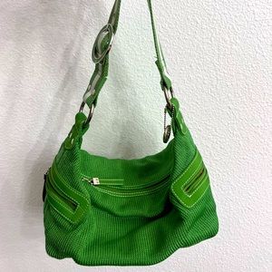 The Sak hobo bag with green and white striped shoulder stripe